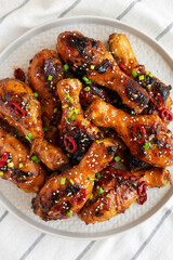 Homemade Easy Sticky Chicken Drumsticks on a Plate, top view. Overhead, from above, flat lay.