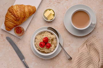 Food photography of oatmeal, oat, porridge, breakfast, croissant, tea, milk, raspberries, butter