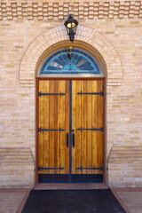 Double wooded entry doors with a stained glass arched transom at Basilica San Albino, Mesilla, New Mexico