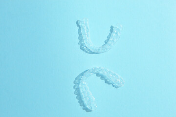 Aligners for straightening teeth on a blue background