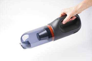 Hand hold vacuum cleaner on white background.