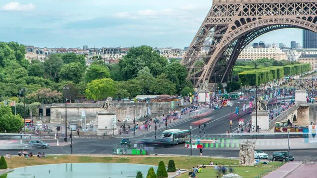 Traffic on intersection near famous square Trocadero with Eiffel tower in the background timelapse. Trocadero and Eiffel tower are the most visited attractions of Paris. Cars on a bridge