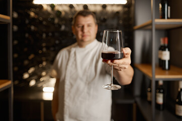Successful male sommelier tasting flavor and checking wine quality