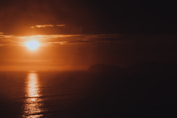 Fototapeta premium Photo of a dramatic sunset over the ocean with storm clouds in the sky (Lima, Perú)