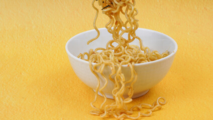 Tasty Fried noodle (Indomie Goreng) on yellow background