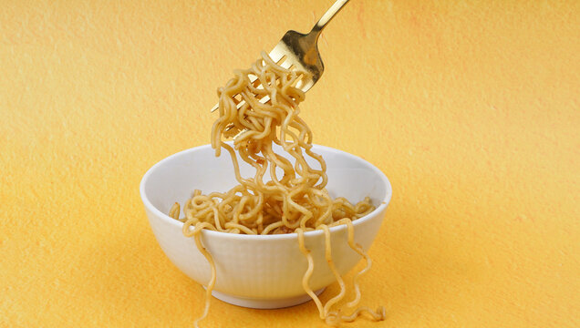 Tasty Fried noodle (Indomie Goreng) on yellow background