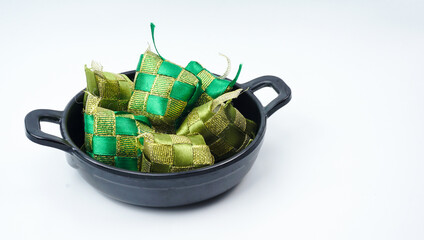 Image of Ketupat or rice dumpling decoration in wok pan