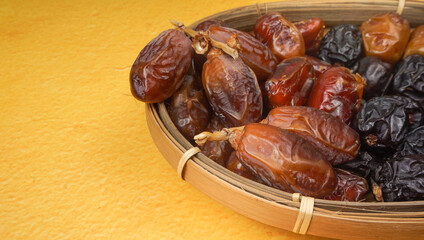 Various of dried dates or kurma in bamboo basket. selective focus