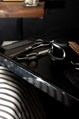 Barber work table with comb, scissors, brush and razor.