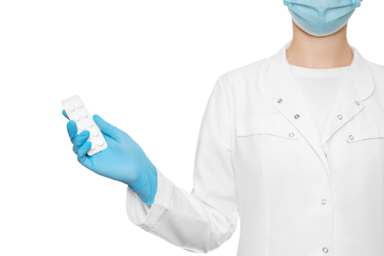 Doctor in a medical gown and glove offers a plate of pills