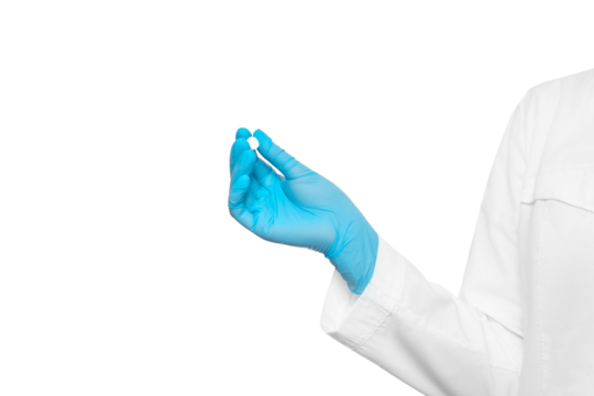 Doctor in a medical gown and glove offers a pill