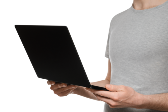 A man in a gray t-shirt holds an ultrabook, laptop in front of him