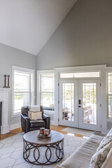 A light and bright open concept living room den with vaulted ceilings in a new construction house