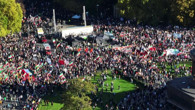 Aerial footage of protesting mass of people with Iranian flags and banners on square. Berlin, Germany