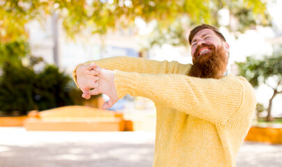 red hair bearded man lazily early in the morning, waking and looking sleepy, tired and bored