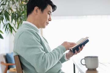 休日に読書をする50代男性