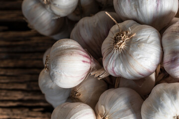 Garlic on wood table close up top view.