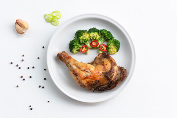 Healthy food grilled chicken has broccoli vegetable in plate on white wood table.