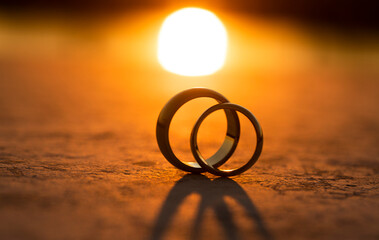 Wedding rings sunset. Love concept. Wedding. Rings. Jewelry. Photo. Couple. Golden. 