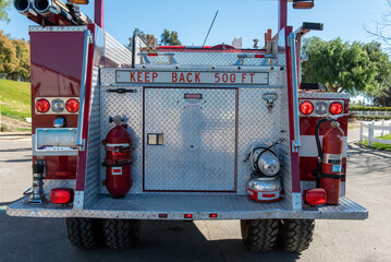 Rear of heavy duty fire truck has taillights illuminated and ready to roll