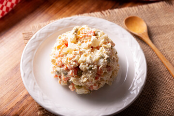 Russian Salad, also known as Oliver Salad. Very popular dish in several countries, the main ingredients are commonly potatoes, mayonnaise and vegetables such as peas, carrots, boiled eggs or chicken.