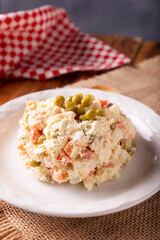 Russian Salad, also known as Oliver Salad. Very popular dish in several countries, the main ingredients are commonly potatoes, mayonnaise and vegetables such as peas, carrots, boiled eggs or chicken.