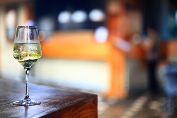 a glass of white wine in a restaurant, alcohol luxury background