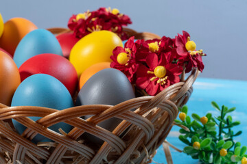 easter basket with straw and colored eggs