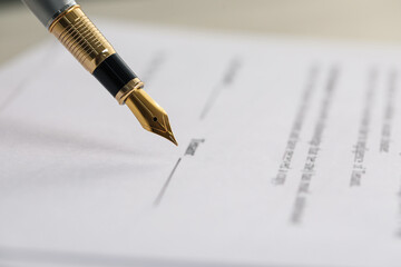 Fototapeta premium Signing document with fountain pen, closeup. Notary services