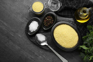 Raw couscous and ingredients on grey table, flat lay. Space for text