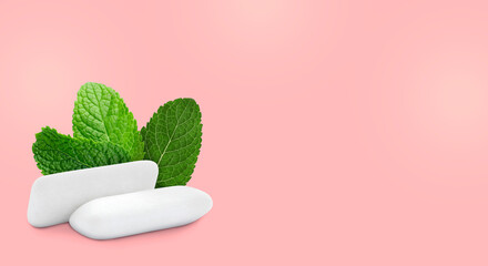 Menthol chewing gum pillows and mint leaves on pink background, space for text. Banner design