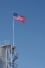 American Flag over an industrial structure