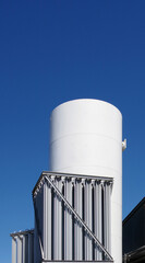 Big industrial silos under blue sky