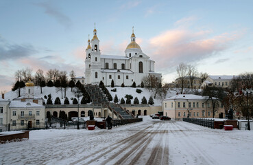 Fototapeta na wymiar View of the Holy Spirit Monastery and the Holy Dormition Cathedral on the Assumption Mountain on a winter day from Pushkin Street, Vitebsk, Belarus