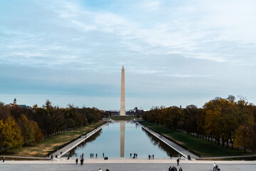 Fototapeta na wymiar Washington D. C. United States. November 29, 2022: Washington Monument with blue sky and reflection in the water.