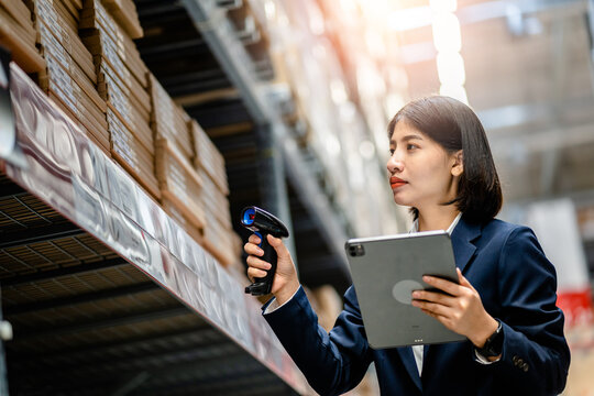 Women managers use scanner checking and scan the barcode of stock inventory to keep storage in a system, Smart warehouse management system, Supply chain and logistic network technology concept.