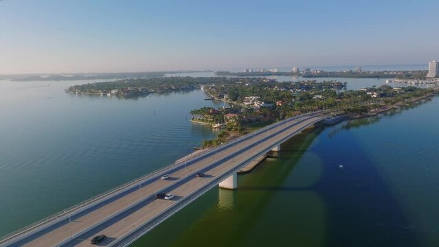 Sunset aerial view of John Ringling Causeway heading toward St. Armand's Circle and Lido Key in Sarasota, Florida.