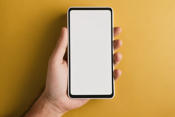 Hand holding mobile phone and blank screen for mockup template with orange background. Created with Generative AI Technology