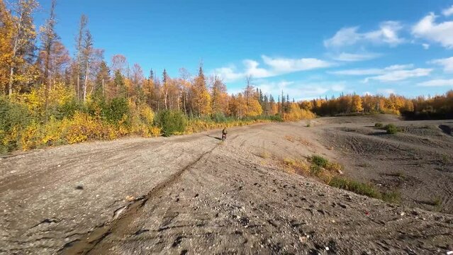 Two brothers riding dirt bikes with FVP drone