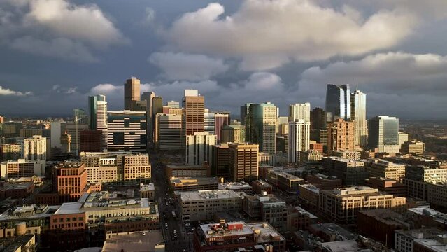 Moody aerial downtown Denver city skyline view at sunset, Colorado metropolis