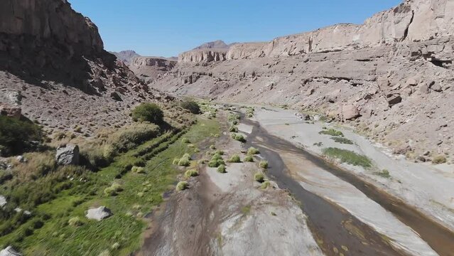 Badakhshan region of Afghanistan. Pyanj river and Pamir mountains. Pyanj is the headwaters of the Amu Darya River. Aerial view of a mountain landscape, sheep, and goats at the mouth of the river.
