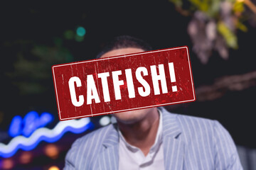 A catfish alert sign or someone pretending to be an attractive person. A fake profile using a stolen photo. A false identity used to pursue deceptive online romance. Catfishing detection concept.