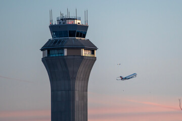 Airport control tower during takeoff airplane