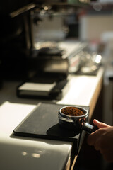 Hand of Barista Holding a Coffee Tamper