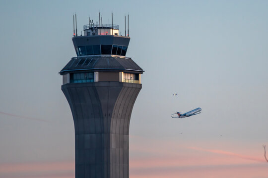 Airport control tower during takeoff airplane
