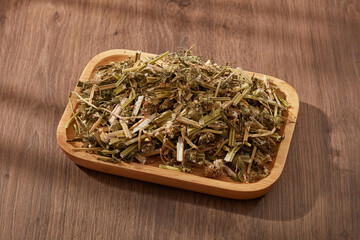 Chinese motherwort (Leonurus japonicus) with dish decorated on wooden table. It reduced risk of heart disease, as well as decreased blood pressure and heart rate caused by stress or anxiety