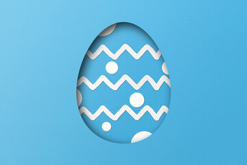 Light blue paper cut to form an Easter egg pattern.