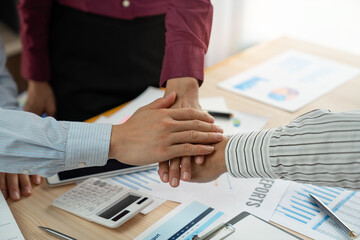 Team of business people join hands after discussing trade agreements to sign agreements and become partners. contract for both companies successful business partnership handshake.