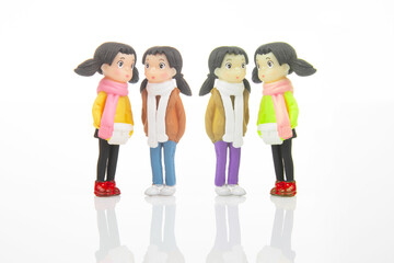 Fototapeta premium miniature people. figures for the game. cute girlfriends together on white background
