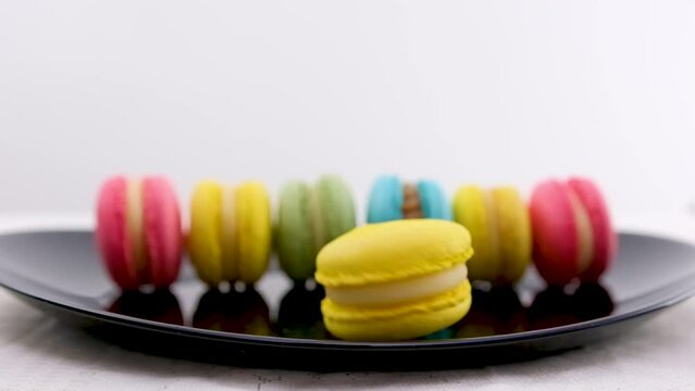 Sweet macarone to spin on yellow background bakery food color sugar pearl french dessert delicious table macaroon slow motion. High quality FullHD footage
